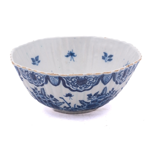 52 - A Dutch blue and white delftware bowl of ribbed rounded octagonal form, painted with birds and insec... 