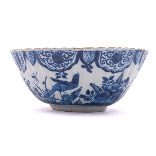 52 - A Dutch blue and white delftware bowl of ribbed rounded octagonal form, painted with birds and insec... 