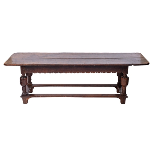 753 - An oak refectory table, elements early 17th century and later; with two plank top above friezes with... 