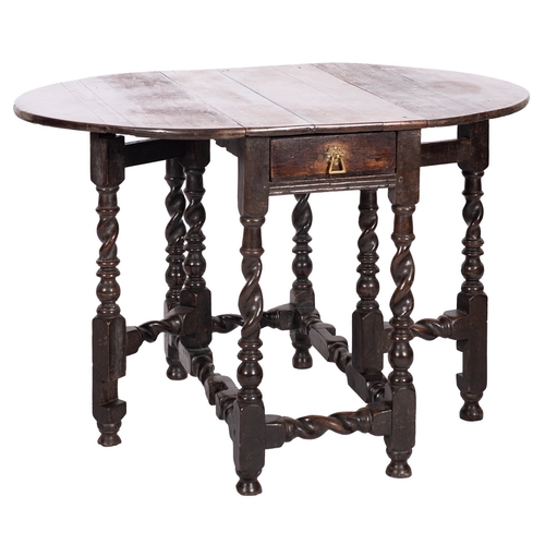 755 - A William and Mary oak gateleg table, late 17th century; the oval top with twin drop leaves, above a... 