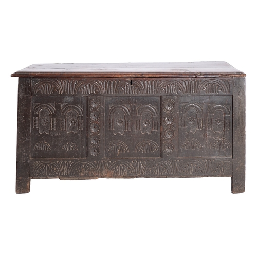 757 - A Jacobean oak coffer, circa 1675; the hinged cover with moulded edges; the front with relief carved... 