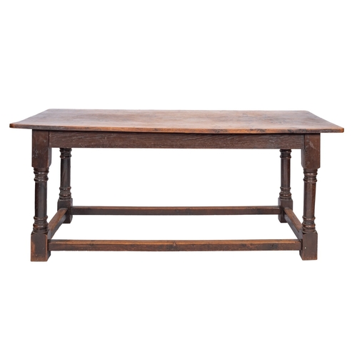 759 - An oak refectory table, early 18th century and later elements; with plain friezes and straight knop-... 