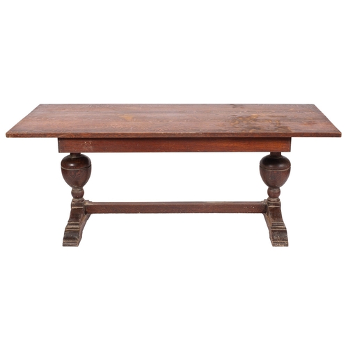 762 - An oak trestle table in 17th century taste, early 20th century; the rectangular top on twin turned b... 