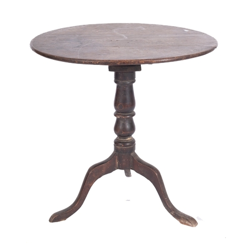 764 - An early 19th Century oak circular occasional table, with a snap top on a turned baluster column and... 