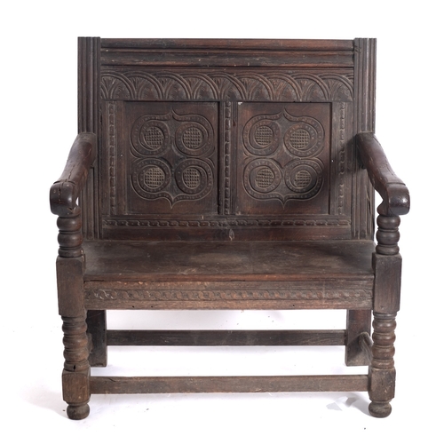 766 - A 17th Century and later oak settle, of small size, the rectangular back with moulded top rail, lune... 