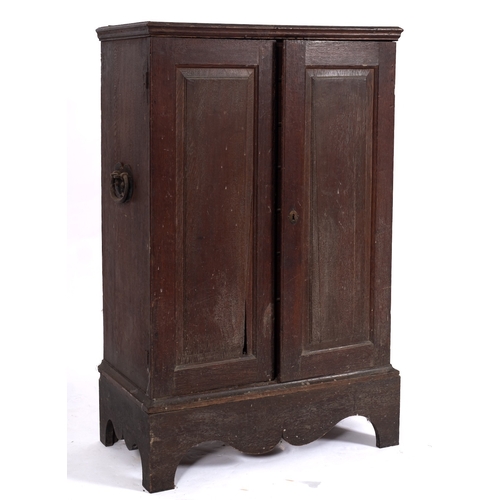 767 - An 18th Century oak Estate Cabinet, on a stand, fitted with fourteen interior drawers, enclosed by a... 