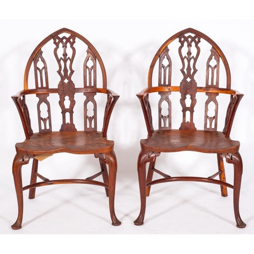 778 - A set of four yew-wood and elm Gothic Windsor elbow chairs in the 18th Century manner, the pointed a... 