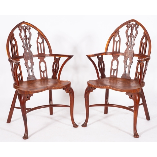 778 - A set of four yew-wood and elm Gothic Windsor elbow chairs in the 18th Century manner, the pointed a... 