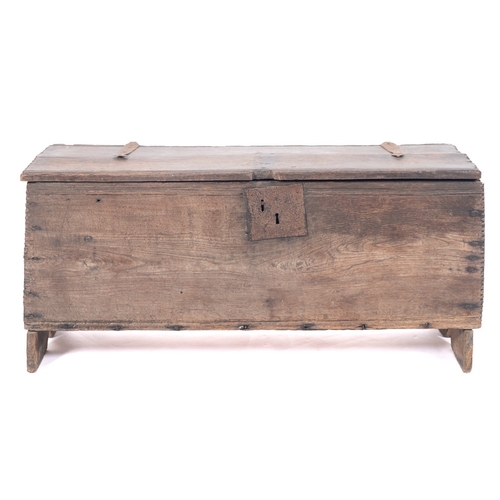 780 - A 17th Century oak rectangular coffer, of plank construction, the hinged top with iron hinges and wi... 