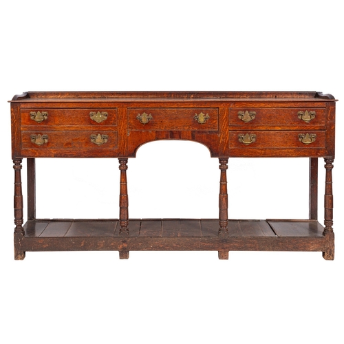 781 - A late 18th Century oak dresser base, with a ledge gallery (formerly with a shelved superstructure),... 