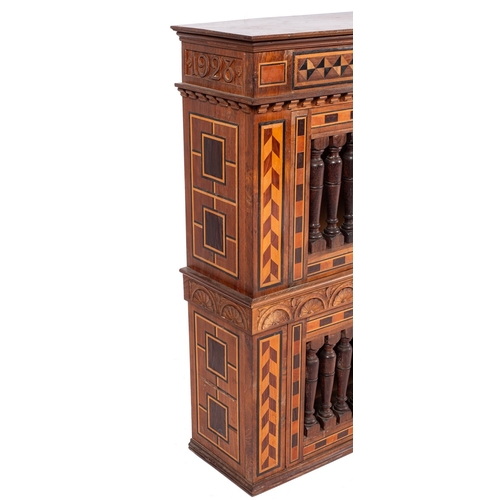 784 - A George V walnut and parquetry cupboard in 17th century taste, dated 1928; with moulded cornice abo... 