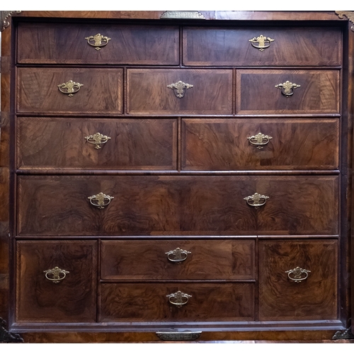 790 - A Queen Anne walnut cabinet on chest, circa 1710, the moulded cornice above two quarter veneered doo... 