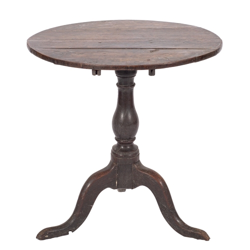 799 - A George II elm circular occasional table, mid 18th century; the flip top on a turned baluster stem ... 