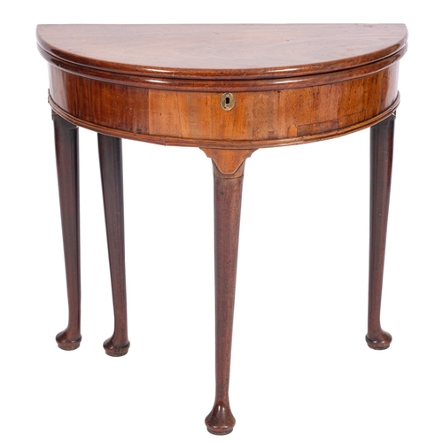 804 - A George II mahogany half round tea table, with a hinged top and box interior, on hipped tapered leg... 