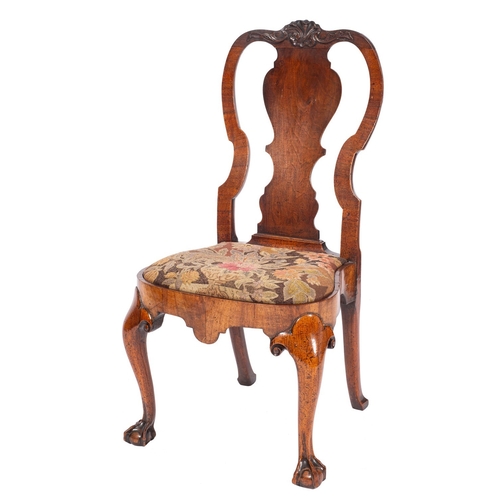 805 - A George I walnut side chair, circa 1720; the backrest with rocaille relief carving above a vase for... 