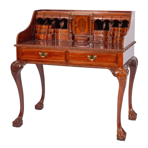 811 - A stained hardwood open bureau in George II taste, second half 20th century; with an array of drawer... 