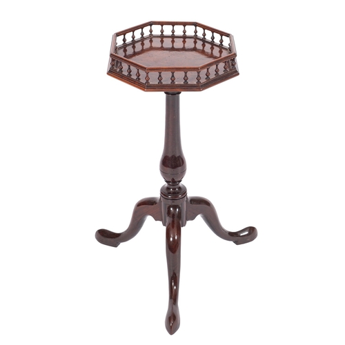 819 - A George II mahogany kettle stand, with an octagonal baluster gallery top, on turned baluster column... 