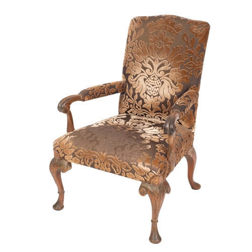 833 - A stained beech open armchair in the George II style, having an upholstered stuff over back, padded ... 