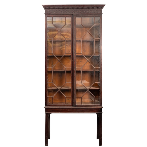 840 - A George III mahogany and glazed bookcase on stand, late 18th century; with moulded and dentilled co... 