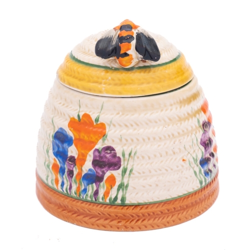 85 - A Clarice Cliff Bizarre beehive honeypot and cover decorated in the 'Autumn Crocus' pattern, printed... 