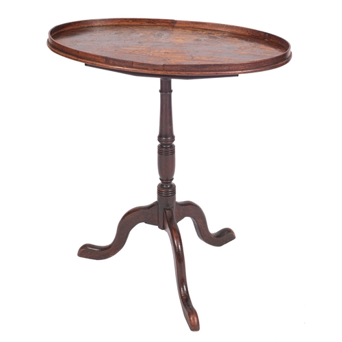 853 - A late George III mahogany oval snap top occasional table, the tray top on ring turned column and tr... 