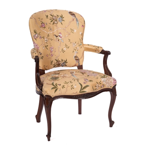 869 - A 19th Century carved mahogany open armchair, in the French Hepplewhite taste with an upholstered st... 