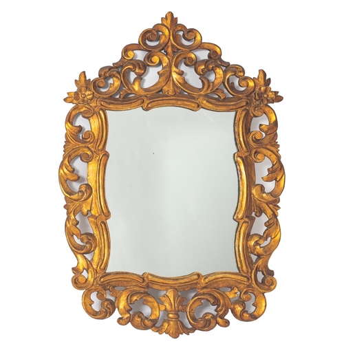 882 - A carved and giltwood framed wall mirror in 18th century style, probably Spanish, 20th century; with... 