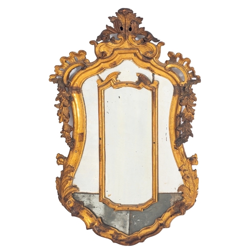 891 - An Italian carved and giltwood framed marginal wall mirror, late 18th century; of cartouche form, wi... 