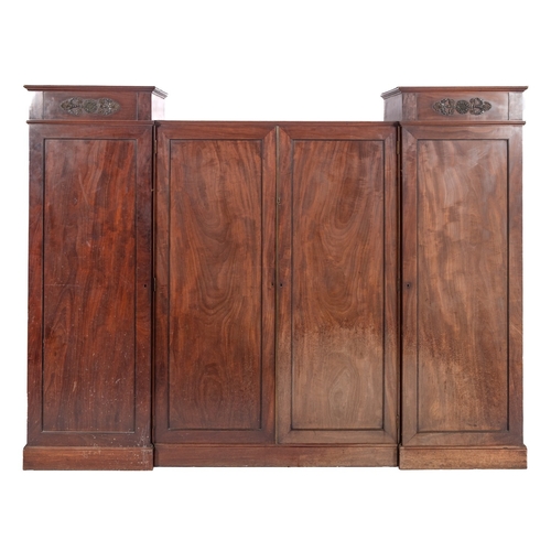 906 - A Regency mahogany and inlaid combination wardrobe, in three sections, with ebonised mouldings, the ... 