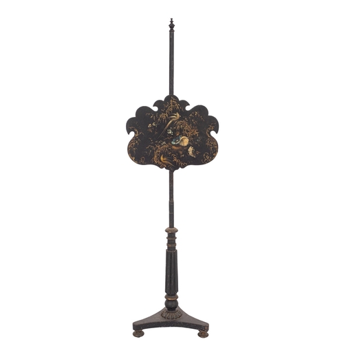 913 - A late Regency ebonised and decorated polescreen, with urn finial and adjustable cartouche shaped pa... 