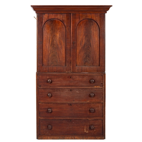 916 - A Regency mahogany linen press, early 19th century and adapted; with moulded cornice above twin arch... 