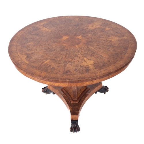 918 - A Regency burr oak centre table, early 19th century; the circular tilt top with a central circular r... 