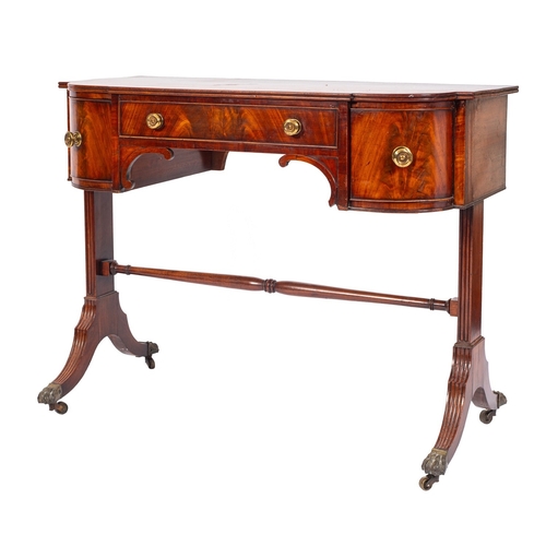 926 - A George IV mahogany bowfront dressing table, circa 1825; the top with reeded edges, above an arrang... 