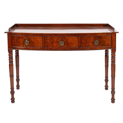 936 - A late 19th Century mahogany bow-fronted dressing table, in Regency style; with a three quarter gall... 