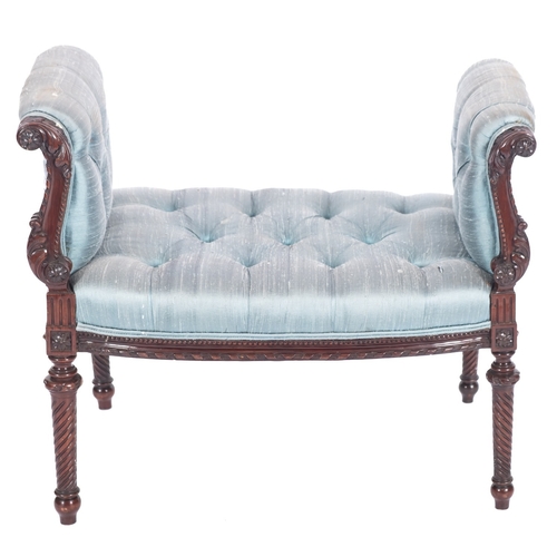 946 - A carved mahogany window seat, in Regency taste, 19th century; upholstered in button down pastel blu... 