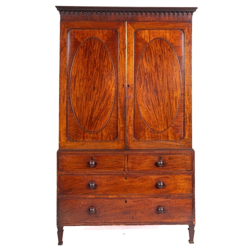 947 - A George IV mahogany linen press, the upper part with a moulded dentil cornice and pendant hung frie... 