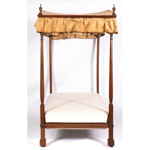 962 - A Victorian mahogany four post single bed, mid 19th century; the arched fabric canopy with moulded c... 