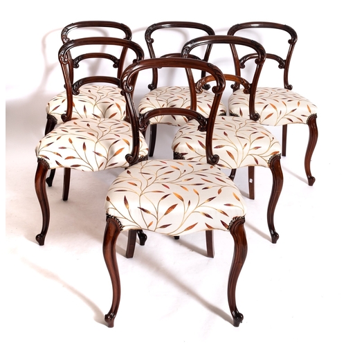 964 - A set of six early Victorian rosewood side chairs, circa 1850; the arched toprails of the backrests ... 