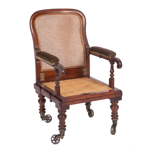 986 - A Victorian mahogany and canework campaign elbow chair, by J. Alderman, London, circa 1865; with hin... 