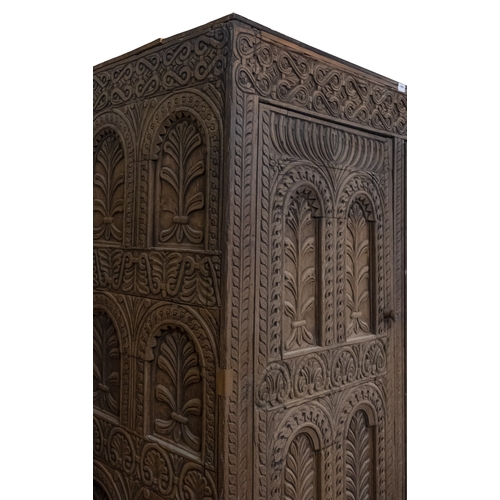 783 - A Jacobean carved oak linen cupboard, basically 17th century with adaptions; the relief carved friez... 