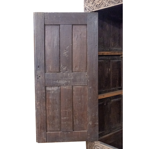 783 - A Jacobean carved oak linen cupboard, basically 17th century with adaptions; the relief carved friez... 