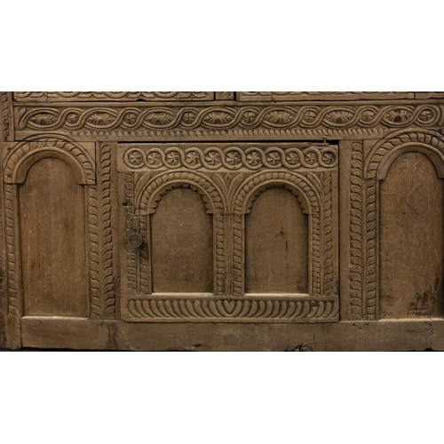 783 - A Jacobean carved oak linen cupboard, basically 17th century with adaptions; the relief carved friez... 