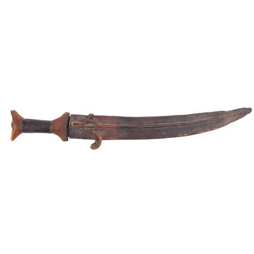 130 - A Middle Eastern horn handled short sword, the slightly curved blade seized in a brown leather scabb... 