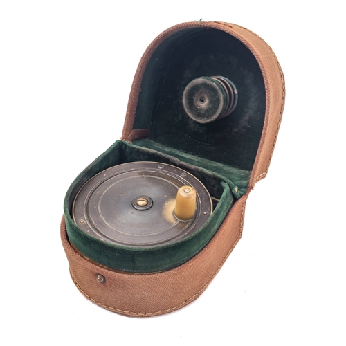 460 - A brass 4 1/12 inch reel with single horn handle in a canvas reel case.