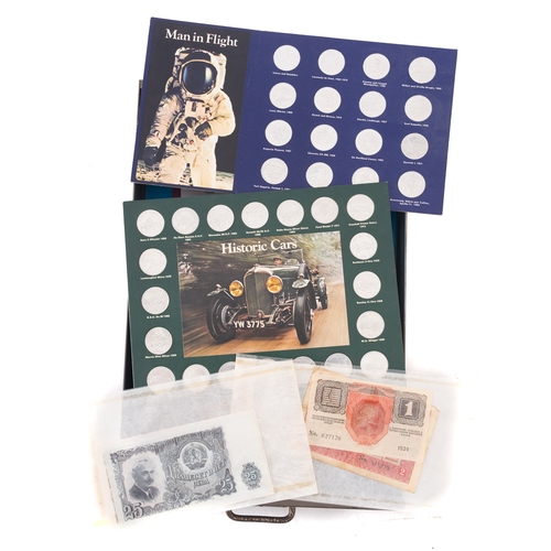 719 - A collection of  £5 coins, £2 coins, 1970 Proof set, world banknotes, 'Man In Flight' set, etc in a ... 