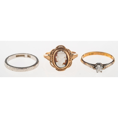 1044 - A group of three rings, including an engraved band, marked PLATINUM, size J1/2, 3.7grams; a cameo se... 