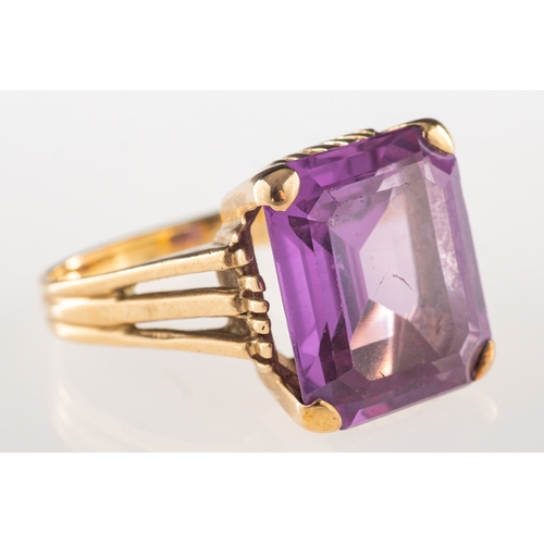 1051 - A dress ring, claw set with a rectangular-cut synthetic alexandrite, unmarked, size L, 5.8grams.