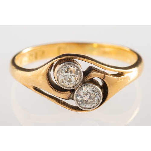 1052 - A two stone diamond ring, an open twist design ring, bezel set with two old-cut diamonds, diamonds a... 