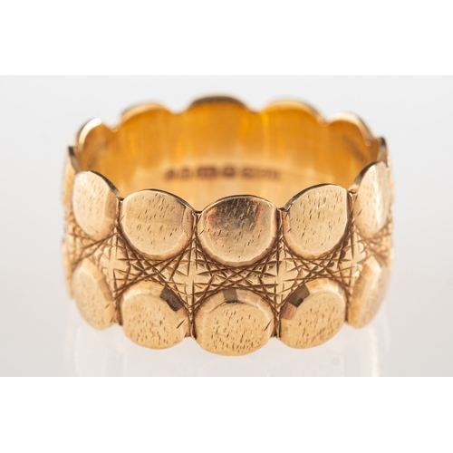 1057 - A 9ct gold wide textured ring, UK hallmark, size R, 6.1grams.