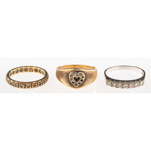 1061 - A group of three rings, including an 18ct white gold seven stone ring, set with seven brilliant-cut ... 